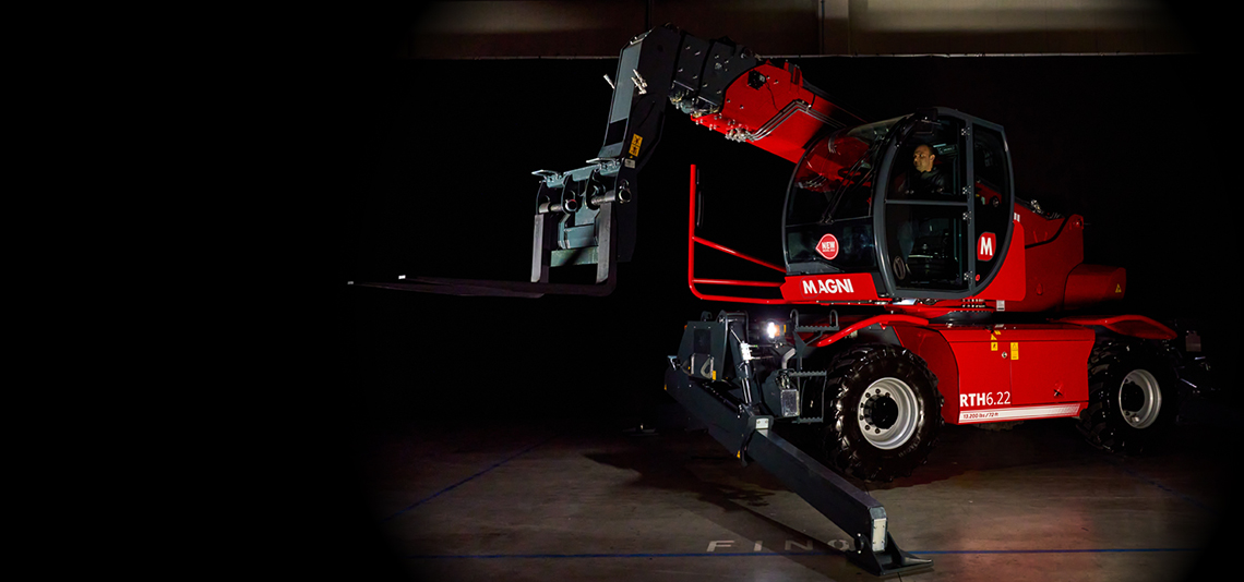 Red rotary telescopic handler in the dark
